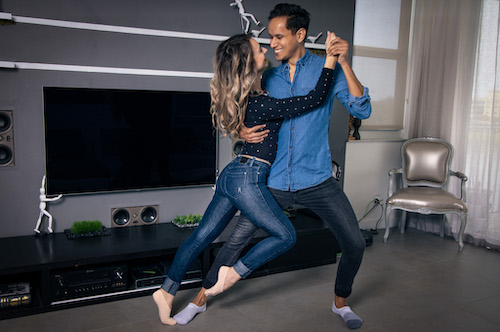 Hervin and Oana dancing in a living room